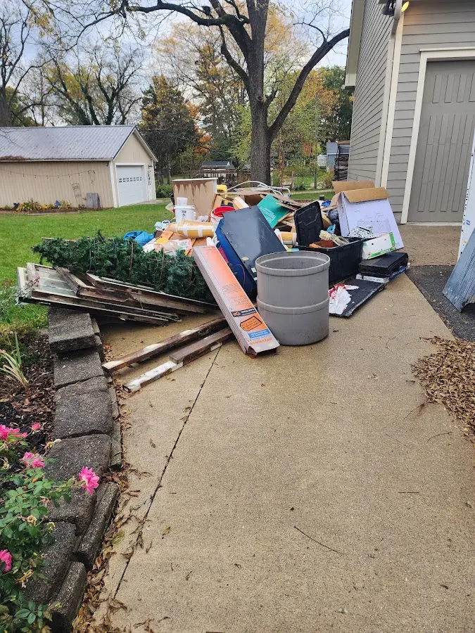 Dumpster being loaded with debris for Estate Cleanout Dumpster Rental in Coral Springs